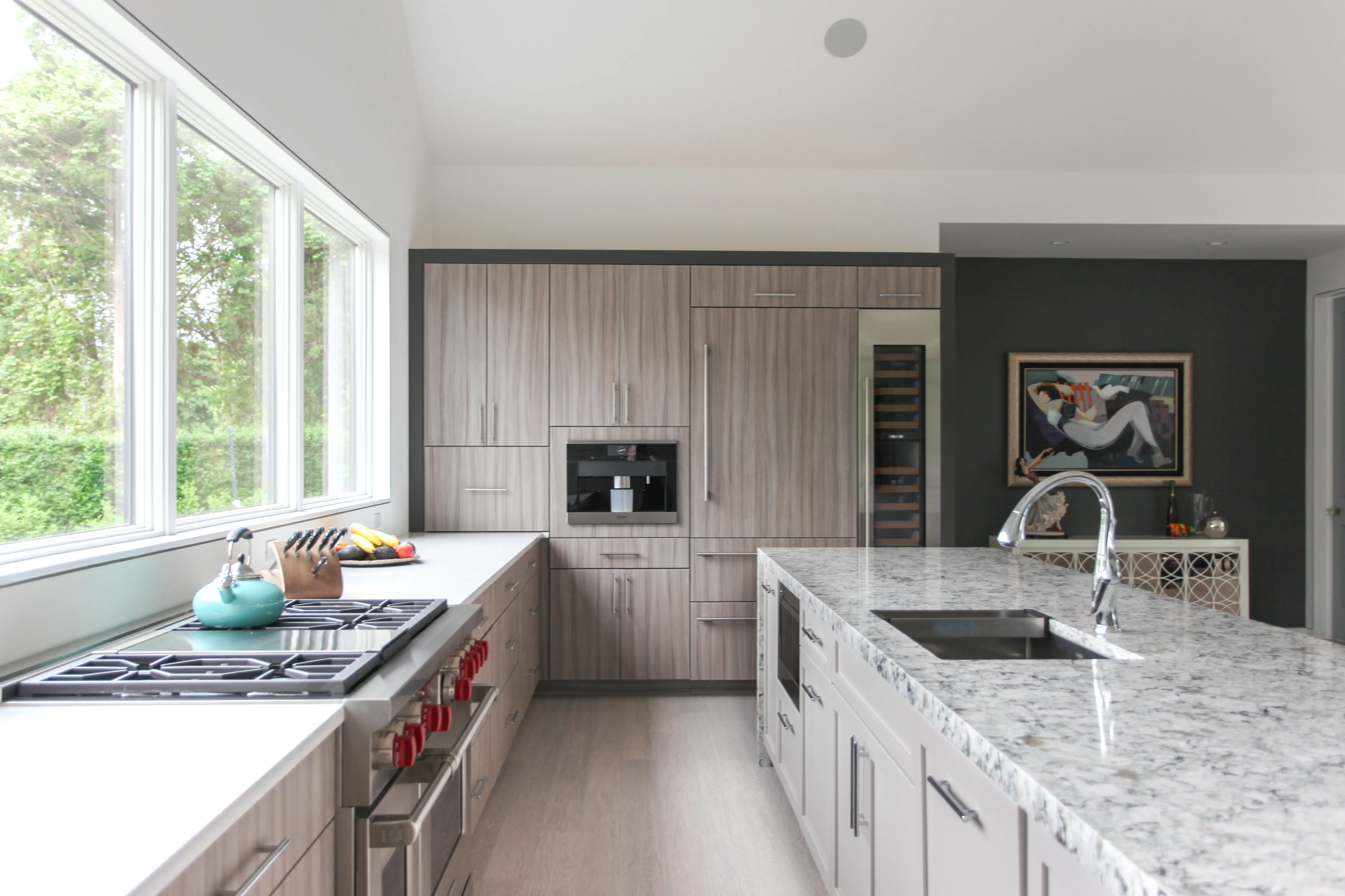 Textured woodgrain slab cabinets with a white island and professional range